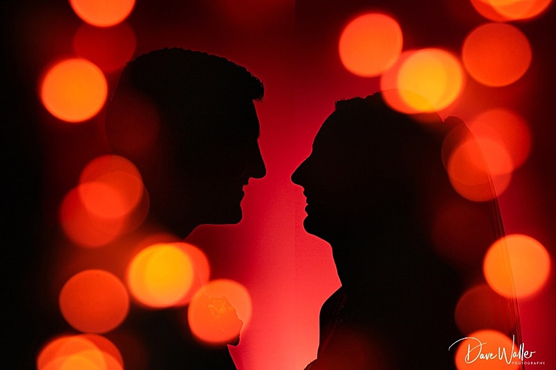 Silhouetted couple with warm bokeh lighting