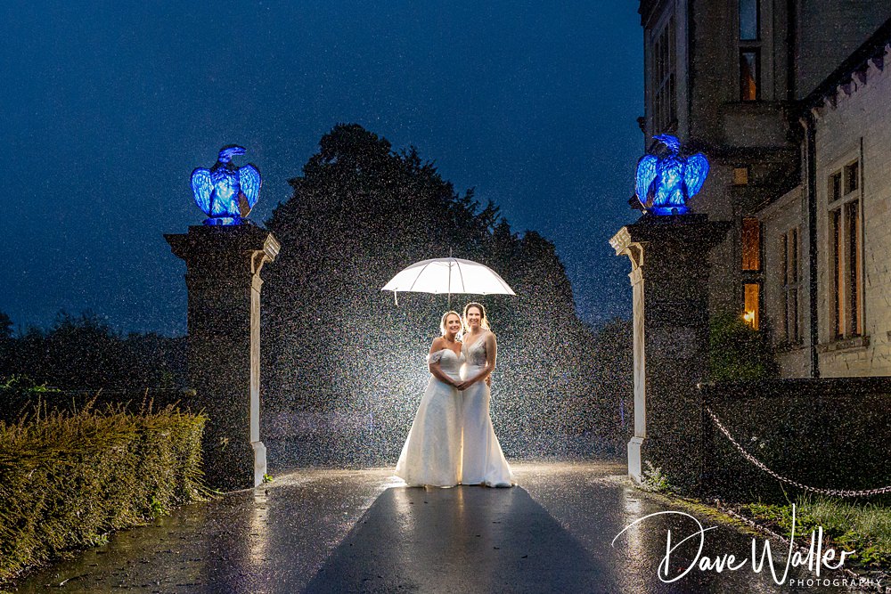 Couple with umbrella at night rain wedding.