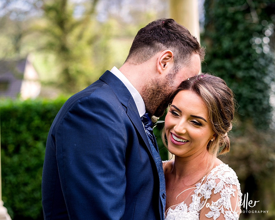 A joyful Emily and Duncan, bride and groom, sharing an intimate moment on their Wentbridge House Wedding day.