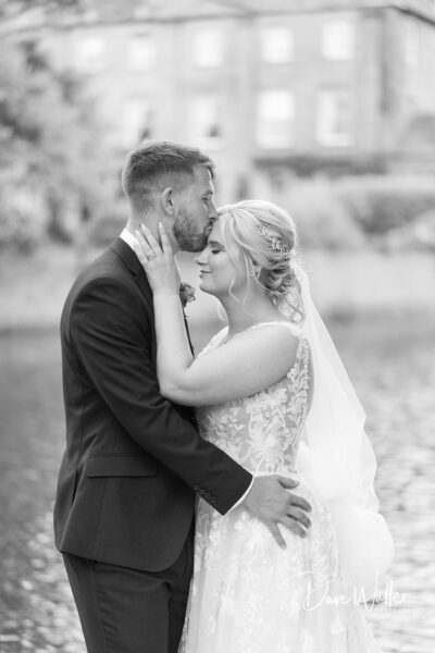 A tender moment captured in black and white at Waterton Park as Hollie & Matt, a newlywed couple, share an intimate gaze, their love and affection for each other palpable in their gentle