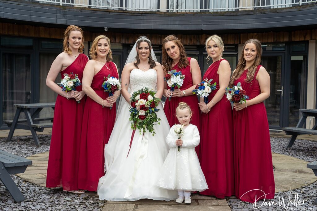 Bride and bridesmaids in red dresses, wedding day.