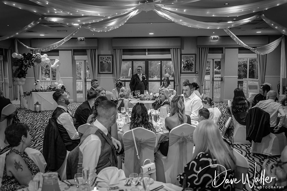 Guests listening to speech at wedding reception.