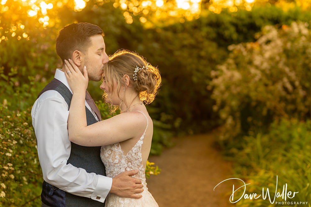 Couple embracing at sunset wedding photography.