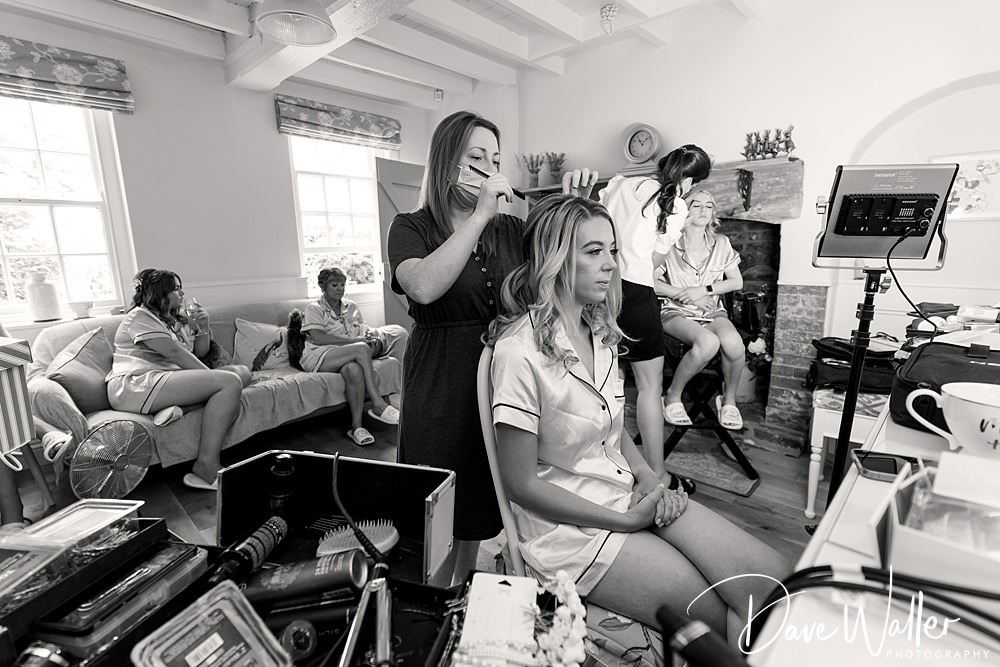 Bridal party preparation, hairstyling and makeup session.