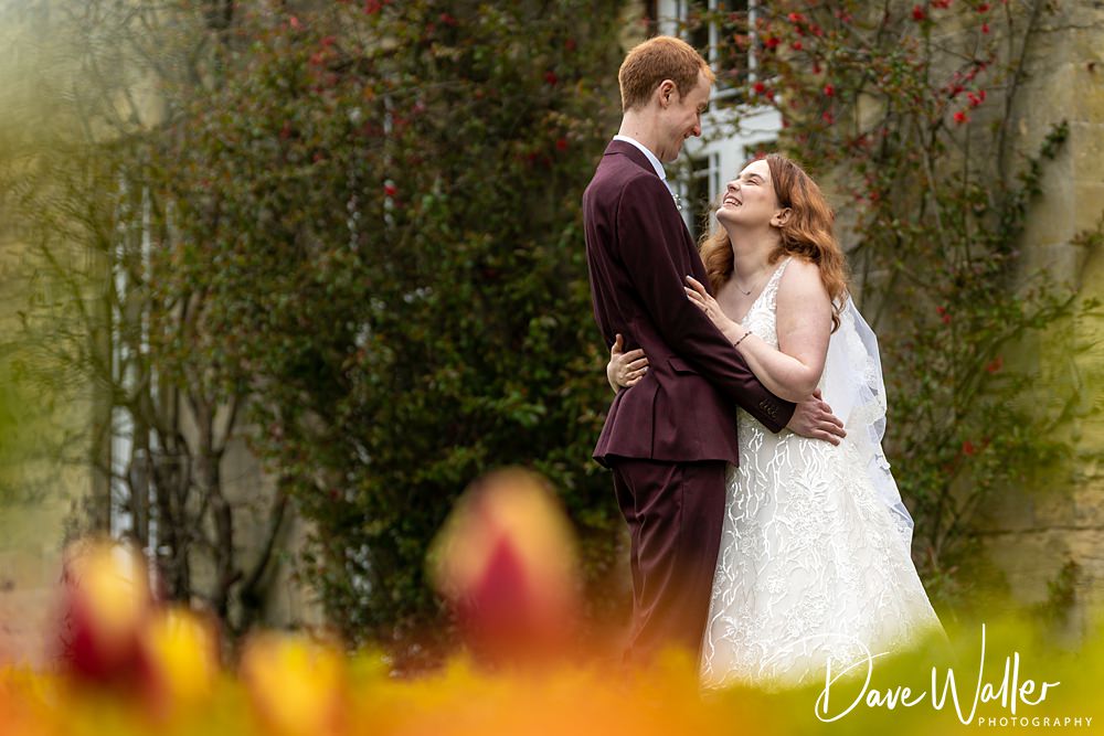 Couple embracing at spring garden wedding.