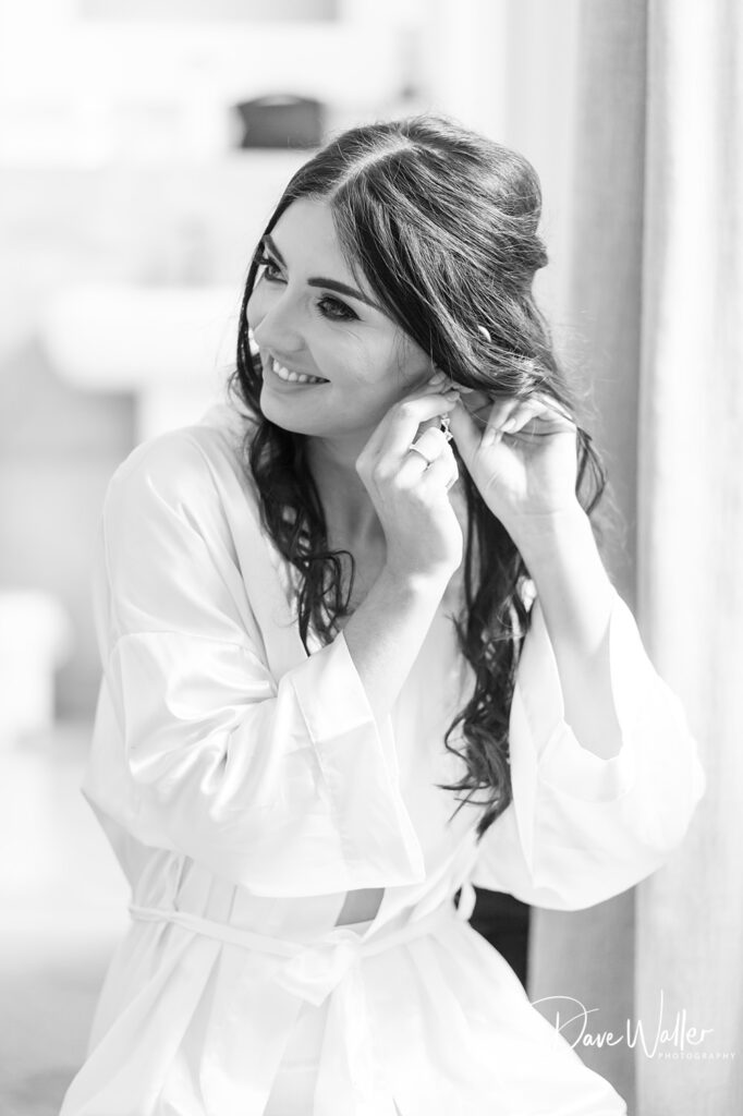 Woman smiling while fixing her hair.