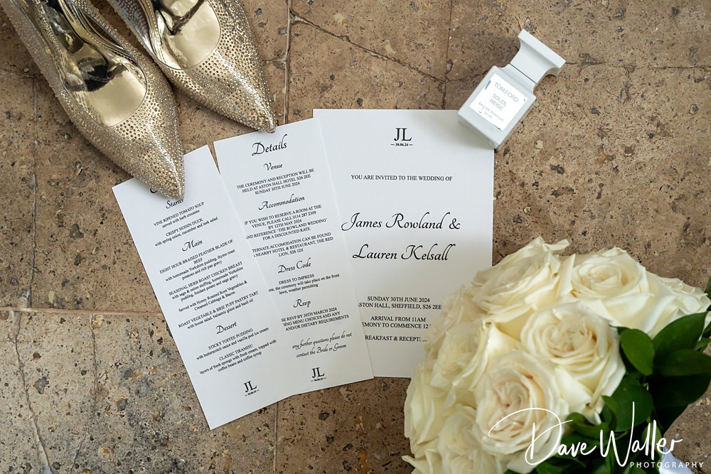 Wedding invitations with shoes and roses.