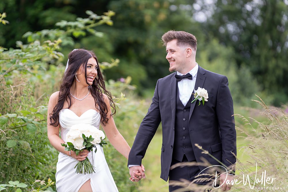 Bride and groom walking in nature.
