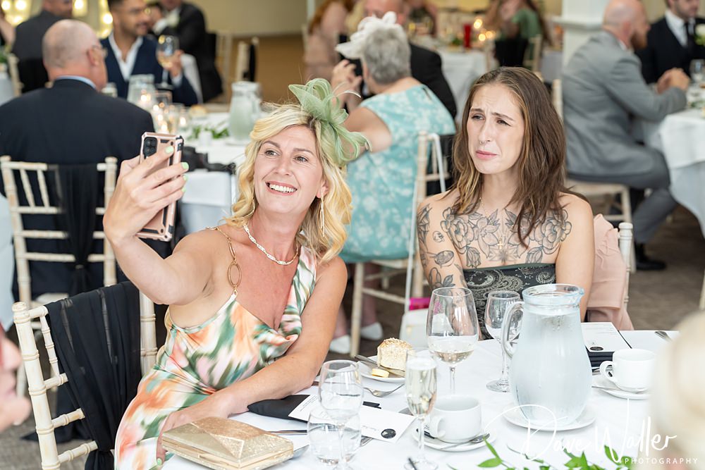 Two women take selfie at elegant event