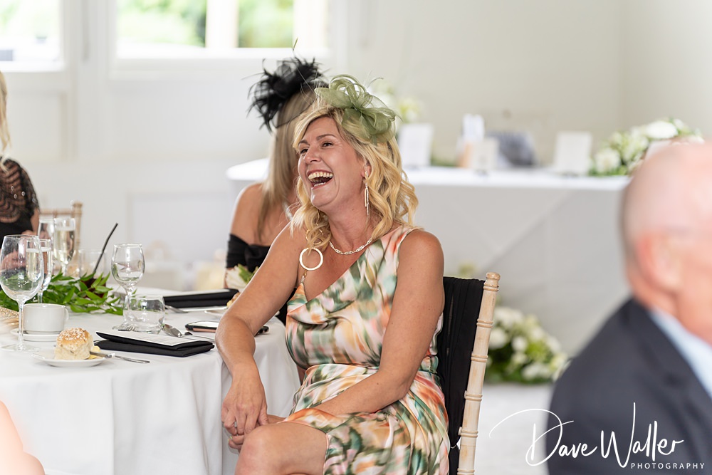 Smiling woman enjoying a formal event.