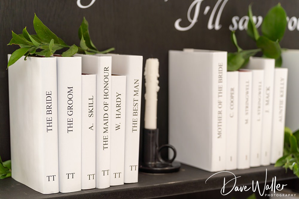 Books with wedding roles as titles on a shelf.