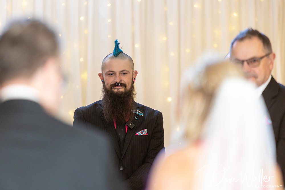 Person with blue mohawk at wedding ceremony.