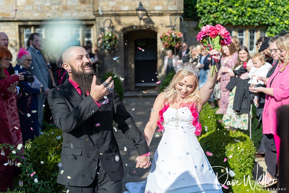 Happy bride and groom celebrating wedding with guests.