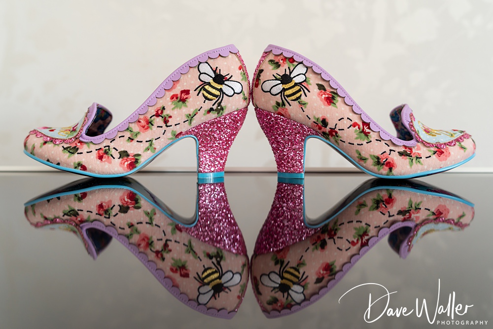 Floral heels with bees, mirrored display.
