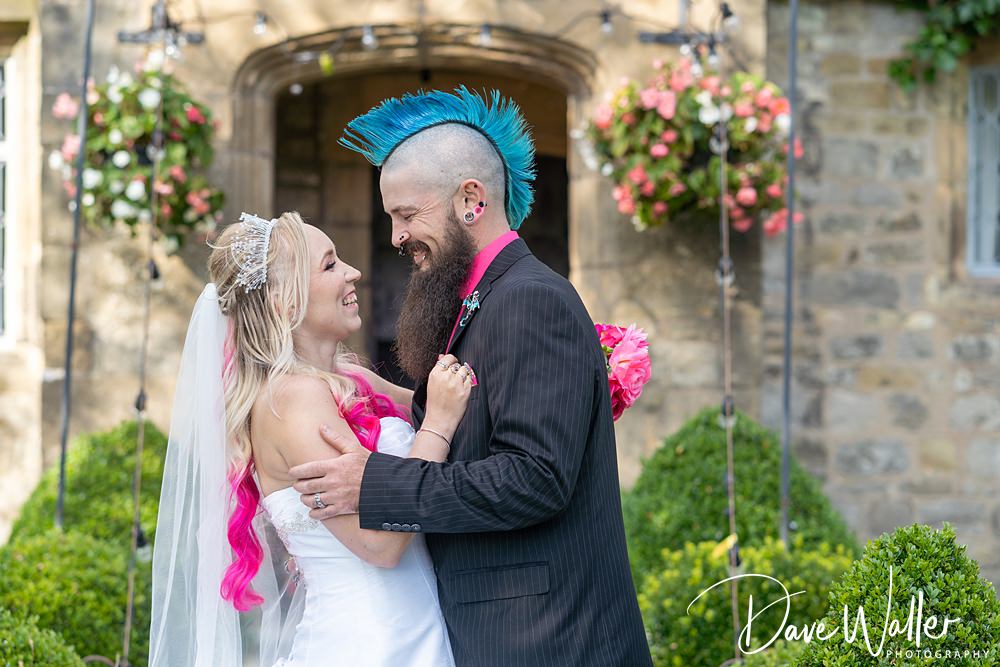 Bride and groom smiling, colourful punk wedding style