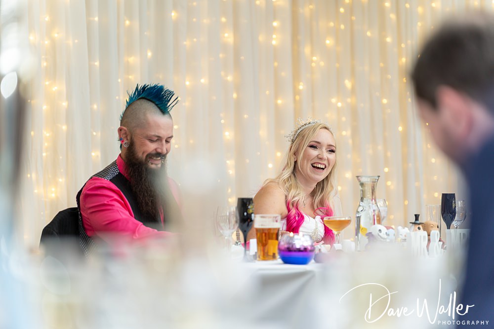 Wedding guests laughing at reception table