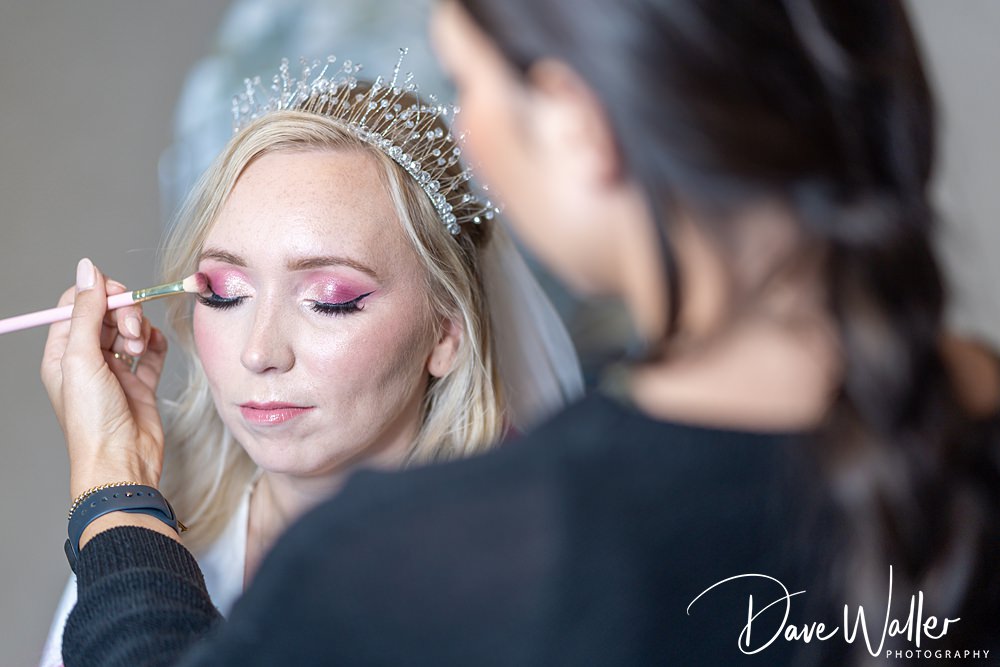 Bride having makeup applied with brush