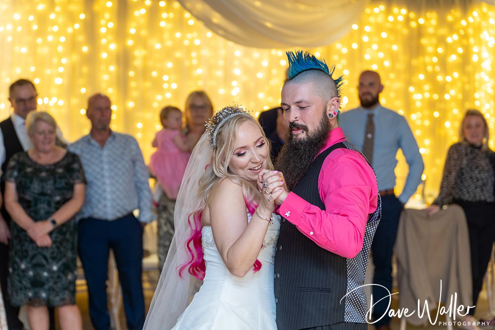 Bride and groom dancing at wedding reception.