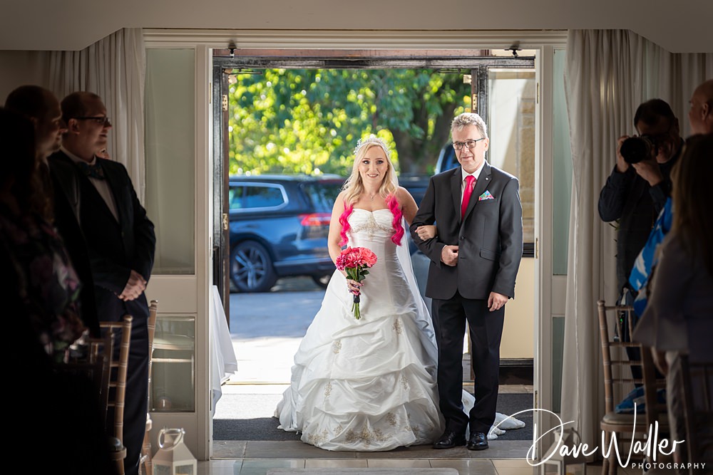 Bride walking down the aisle with father.