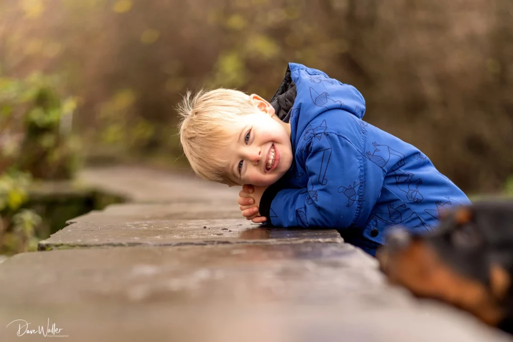 Smiling child in blue coat outdoors