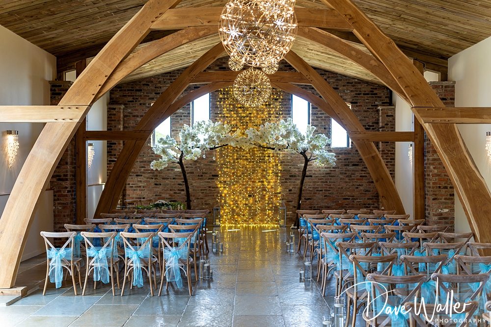 Rustic wedding ceremony setup with floral decorations.