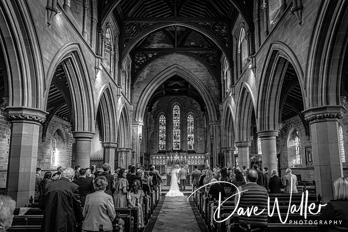 Wedding ceremony in a grand, historic church interior.