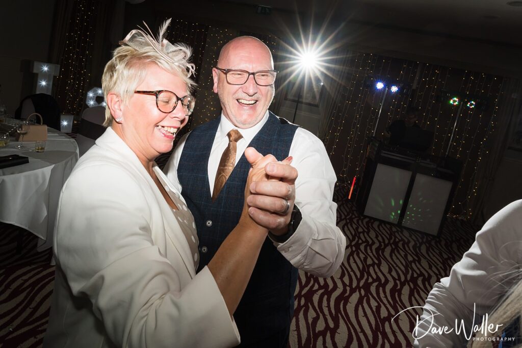Smiling couple dancing at evening celebration