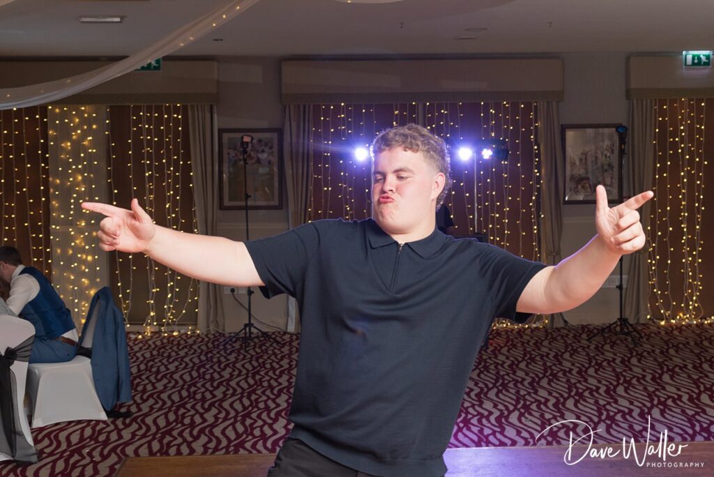 Young man dancing playfully at party venue