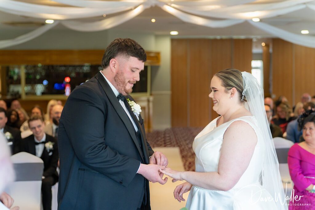 Bride and groom exchanging rings at wedding ceremony