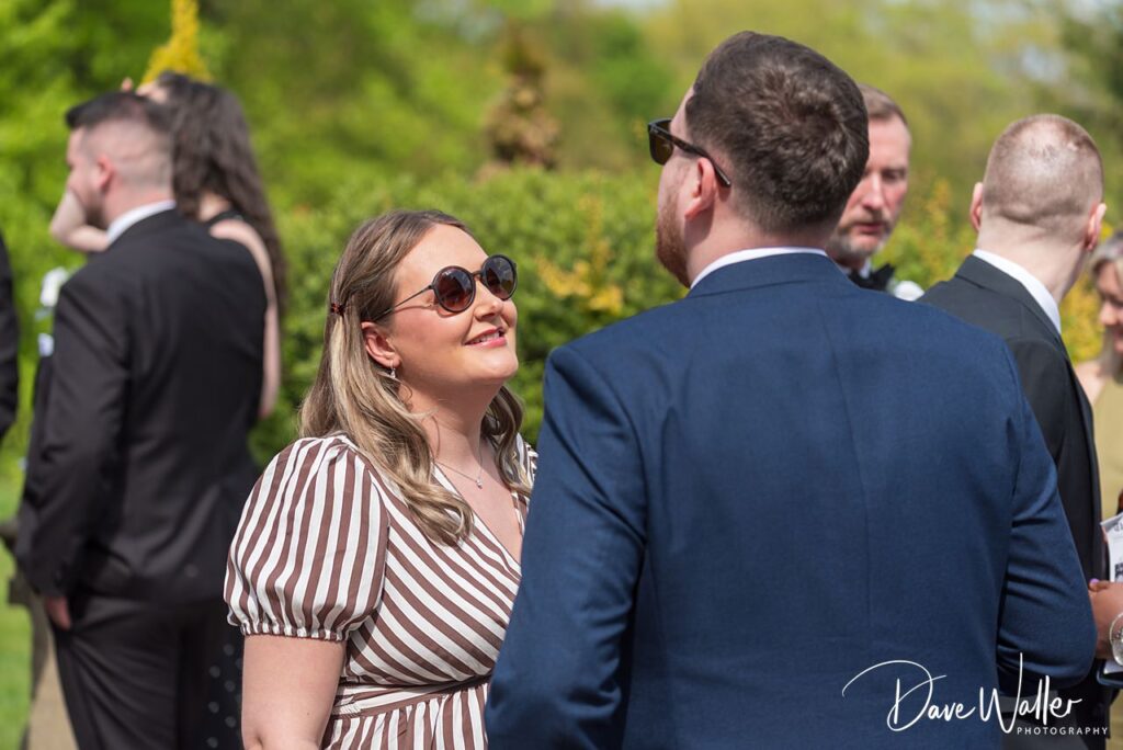 Guests chatting at outdoor summer wedding reception