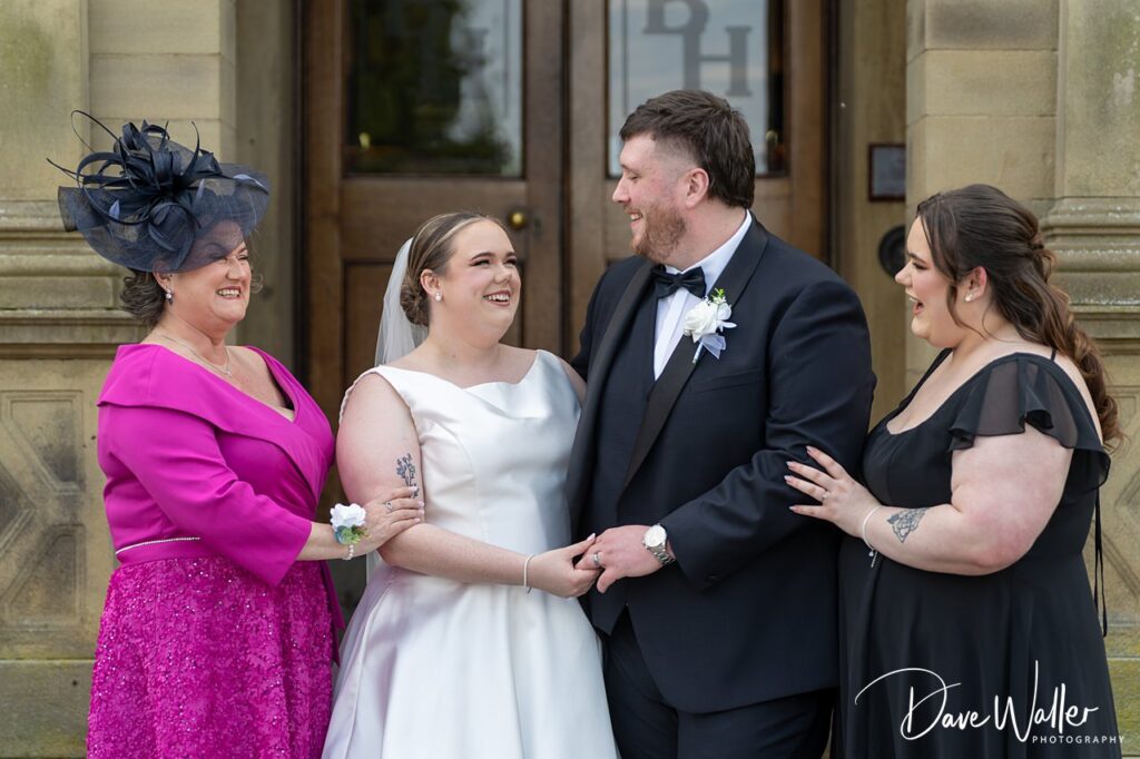 Bride and groom with family outside venue