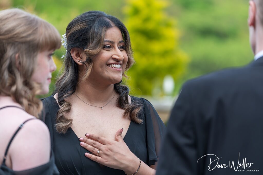 Smiling woman in black dress at outdoor event