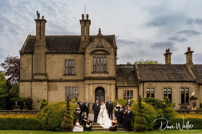 Wedding party outside historic stone manor house