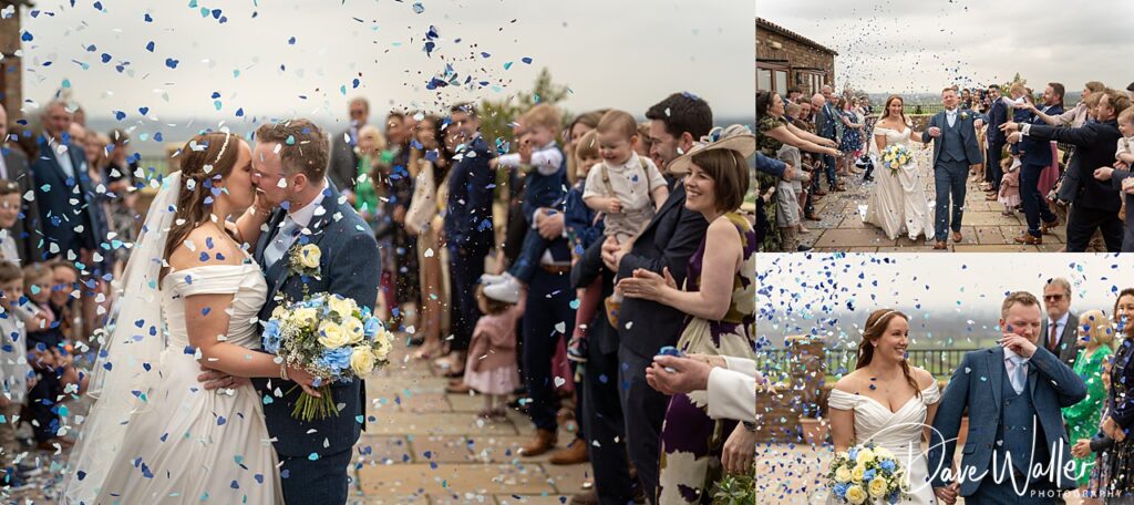 Couple kissing, surrounded by guests and confetti.