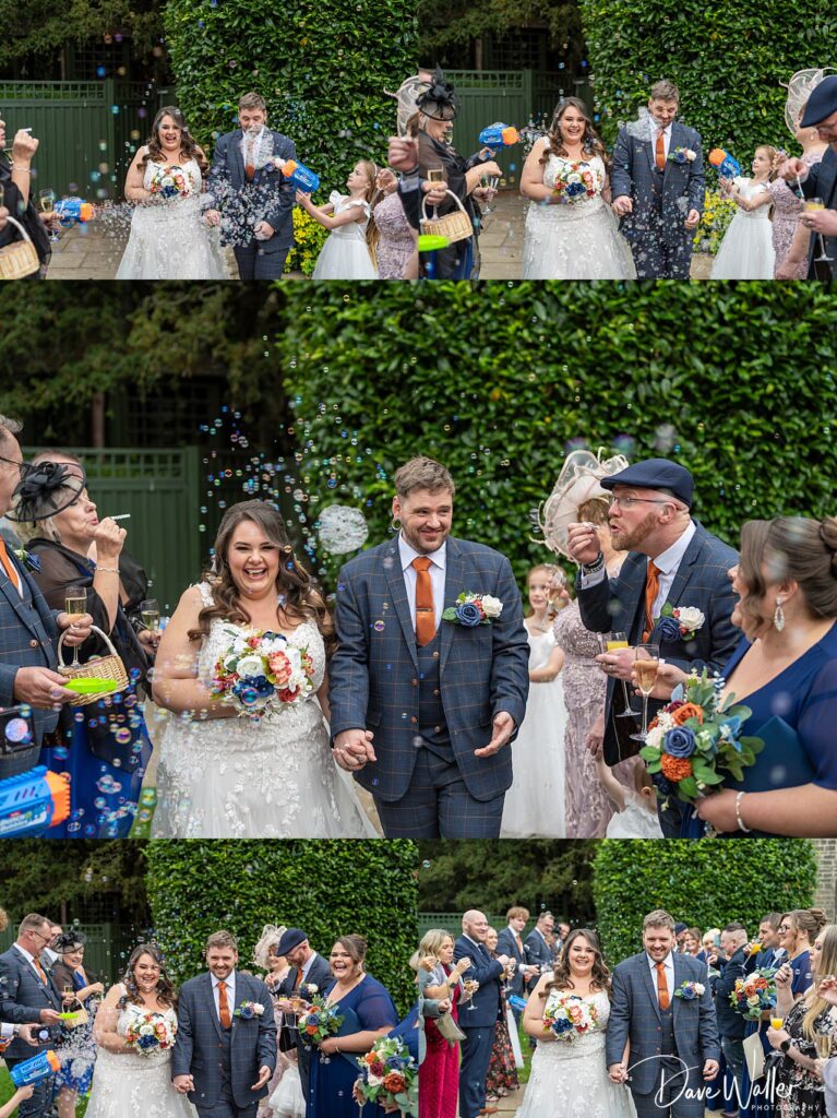 Happy couple exits wedding with bubbles celebration.