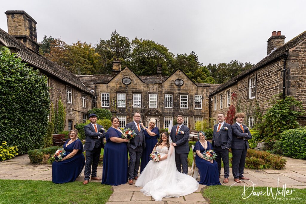 Wedding party posing outside a historic building.