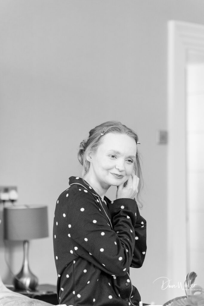 Woman preparing for an event, applying earrings.