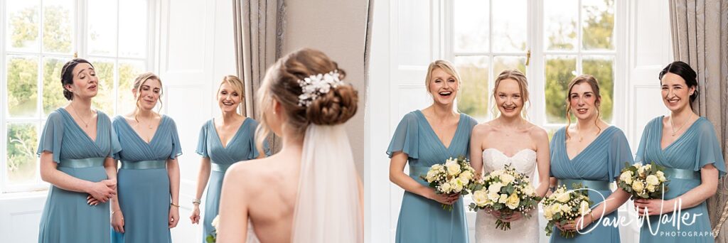 Bridesmaid group smiling with bride in wedding dress.