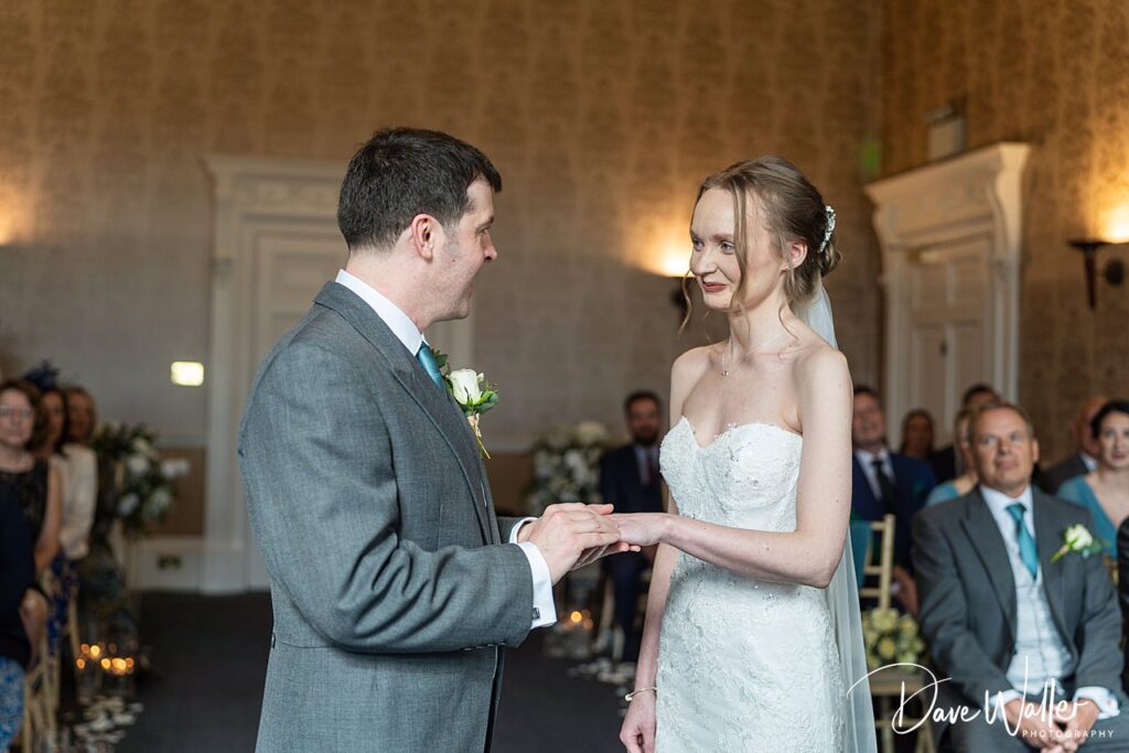 Bride and groom exchanging vows at wedding ceremony.