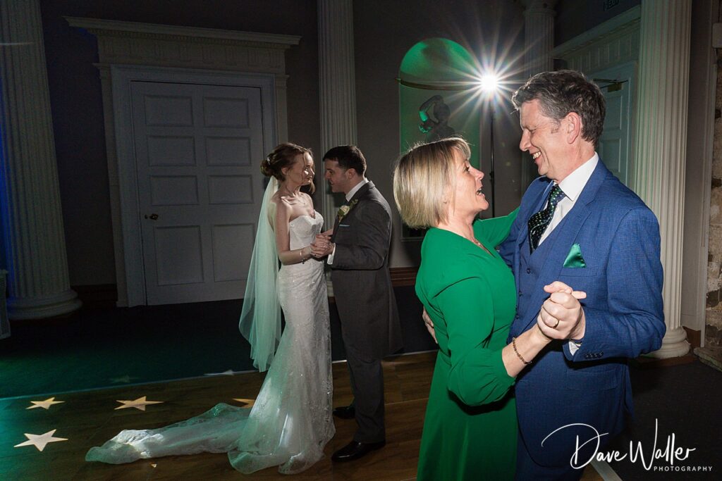 Couples dancing at an elegant wedding reception.