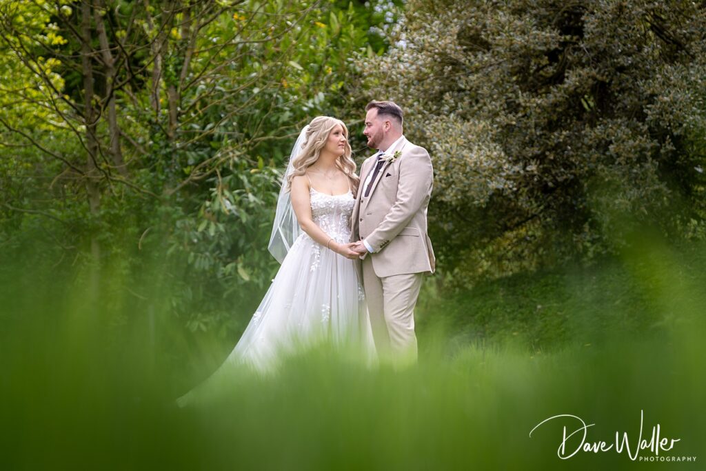 Bride and groom in garden wedding scene.