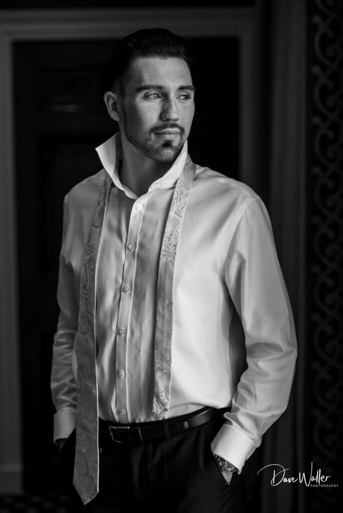 Man in formal attire looking thoughtful sideways