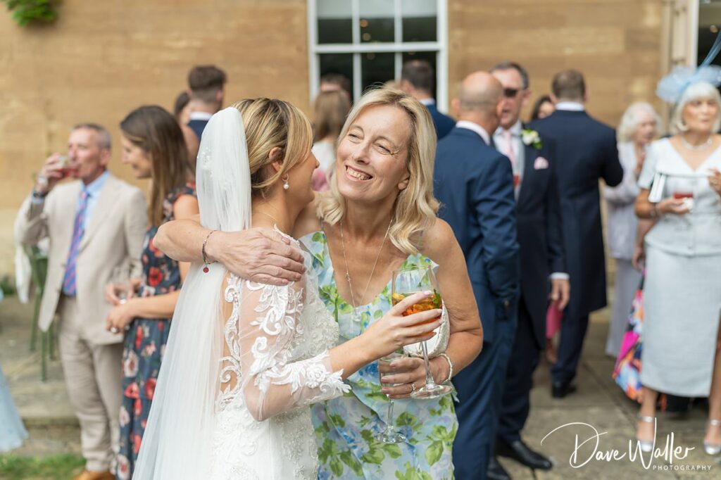 Bride and guests celebrating outdoors at wedding