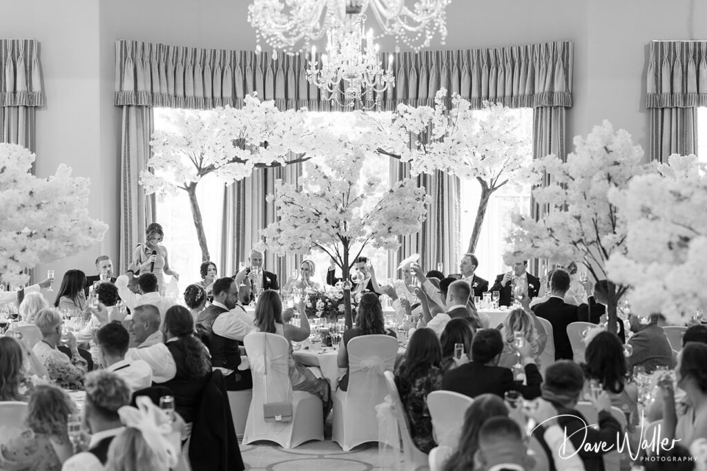 Guests celebrating at elegant wedding reception.