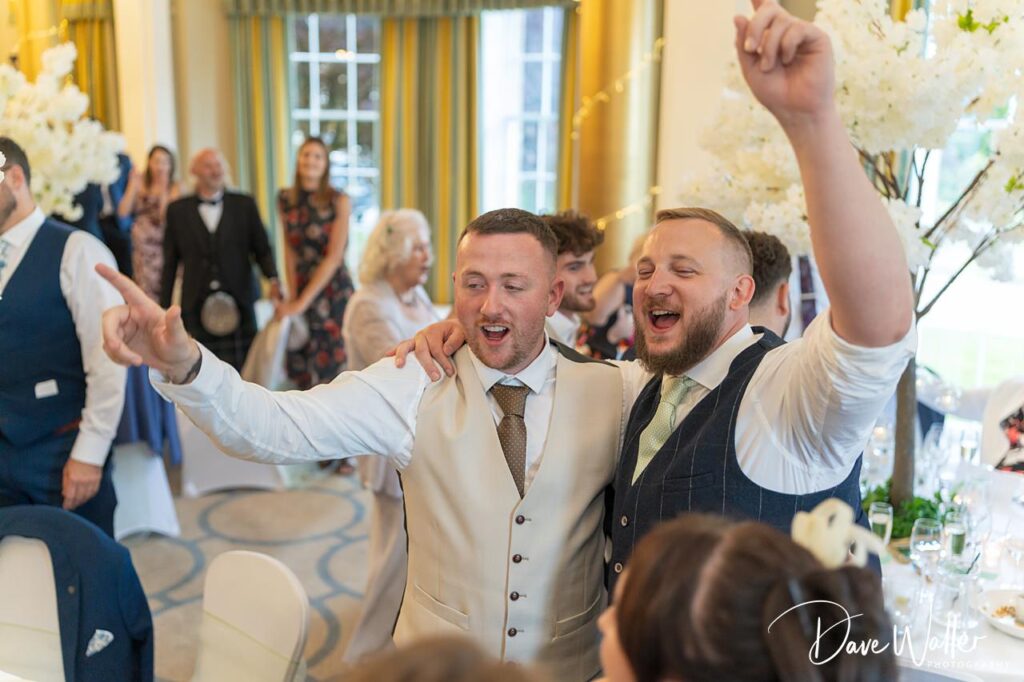 Guests celebrating at wedding reception.