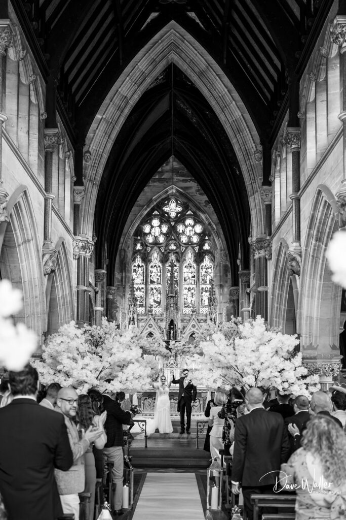 Couple weds in a grand cathedral ceremony.