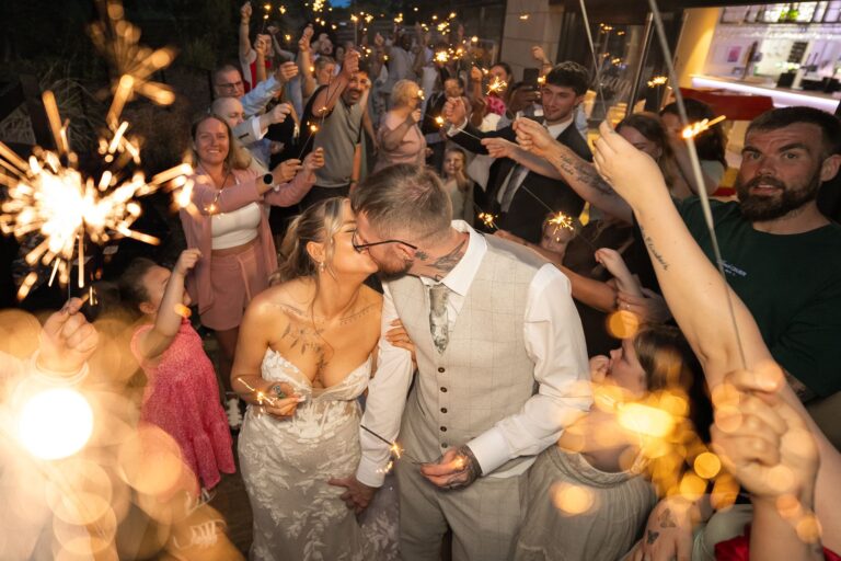 A sparkler kiss surrounded by friends and family at Aston Hall, Sheffield