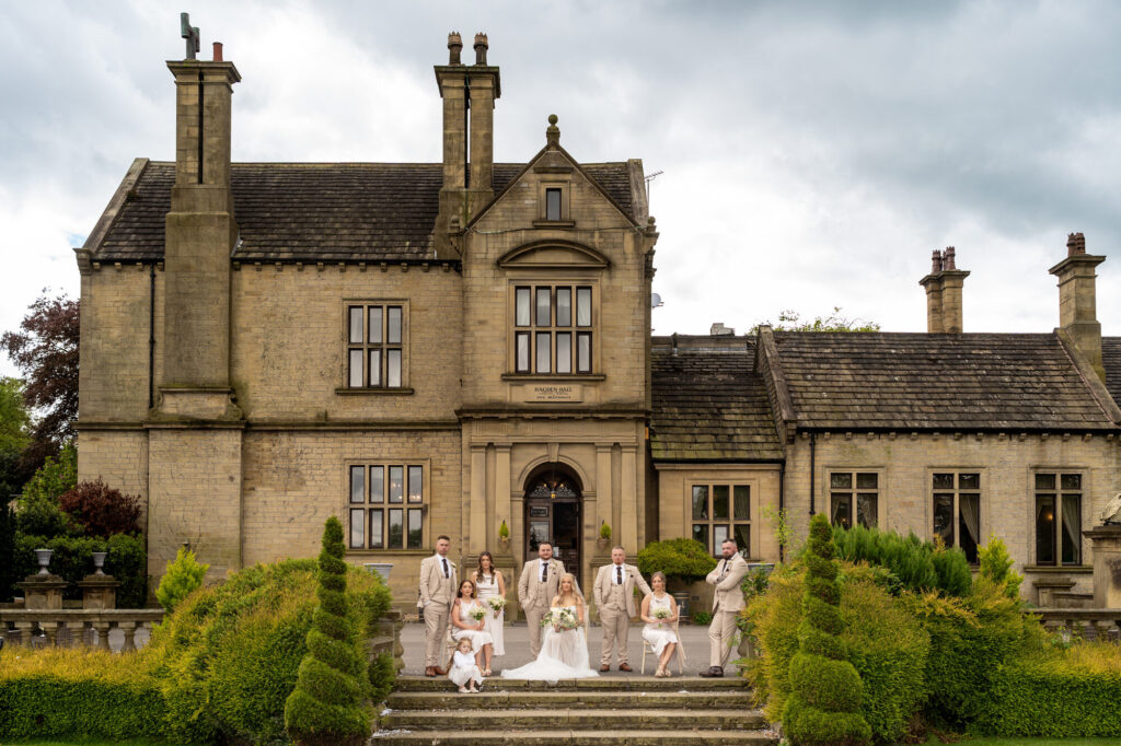 Wedding party group photograph on the steps at Bagden Hall