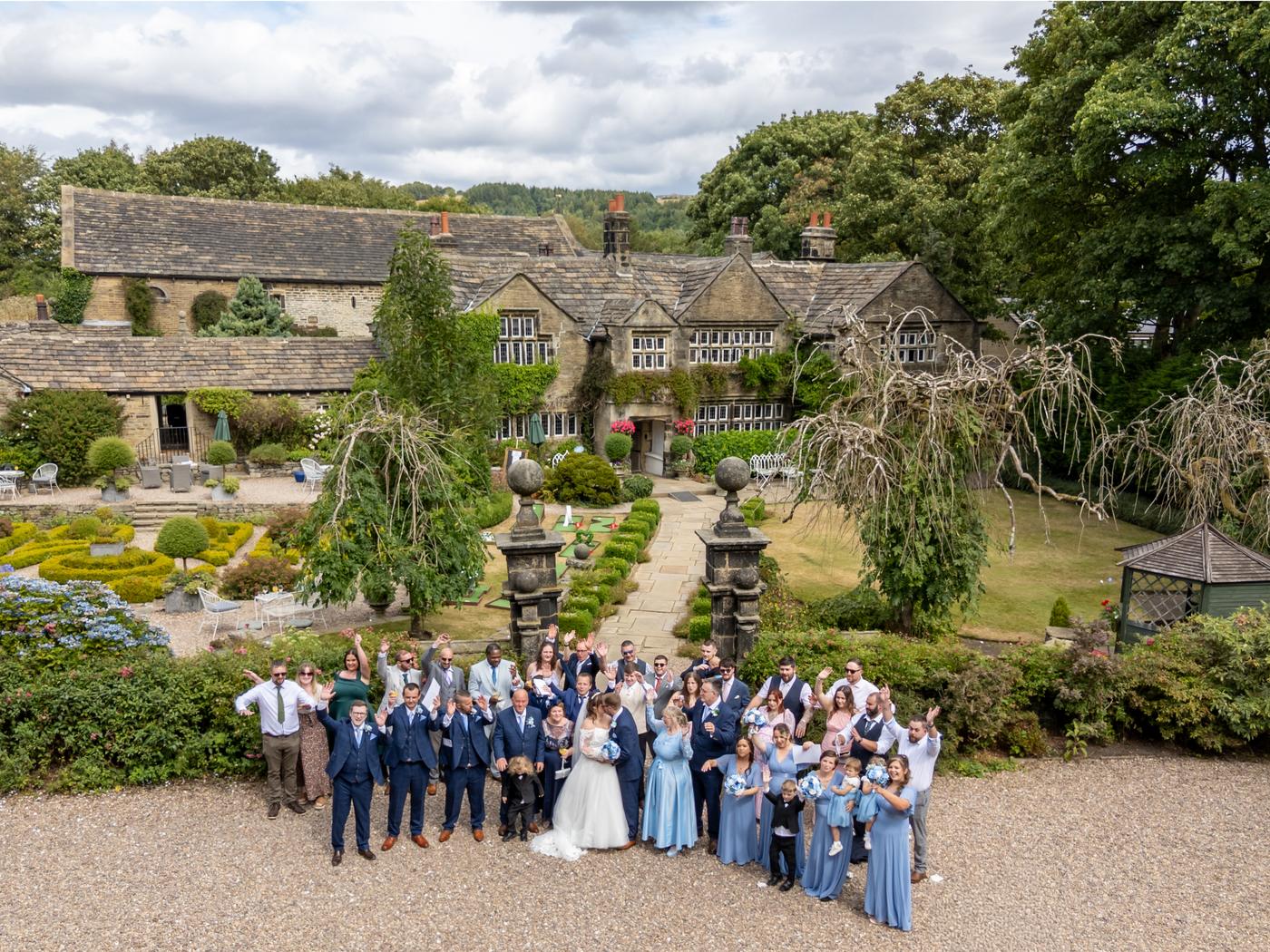 Drone group picture of every guest in front of Holdsworth House near Halifax