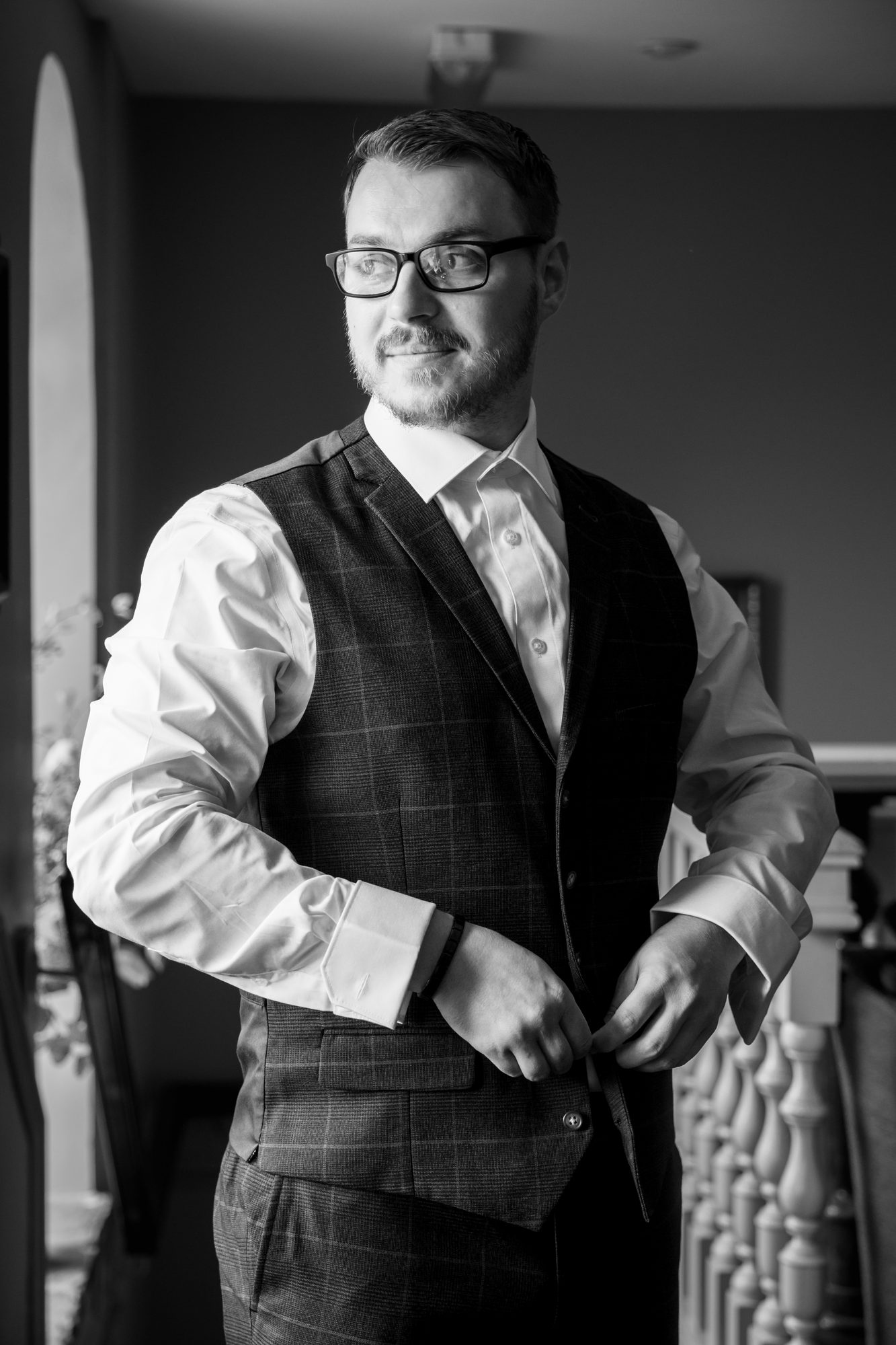 Scott fastening his waistcoat while getting ready at Holdsworth House